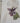 White tote bag with a purple flower design and a visible brand tag 