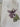 White tote bag with a purple flower design and a visible brand tag 