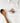 White apron with otter design and wooden spoon on a white background